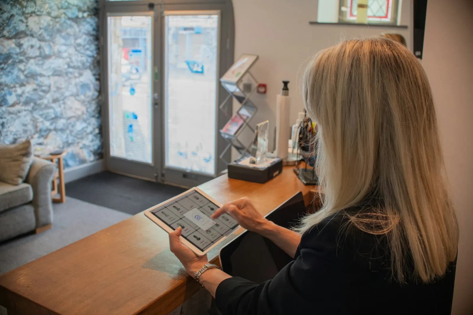 Visitor checking in at a small office front desk