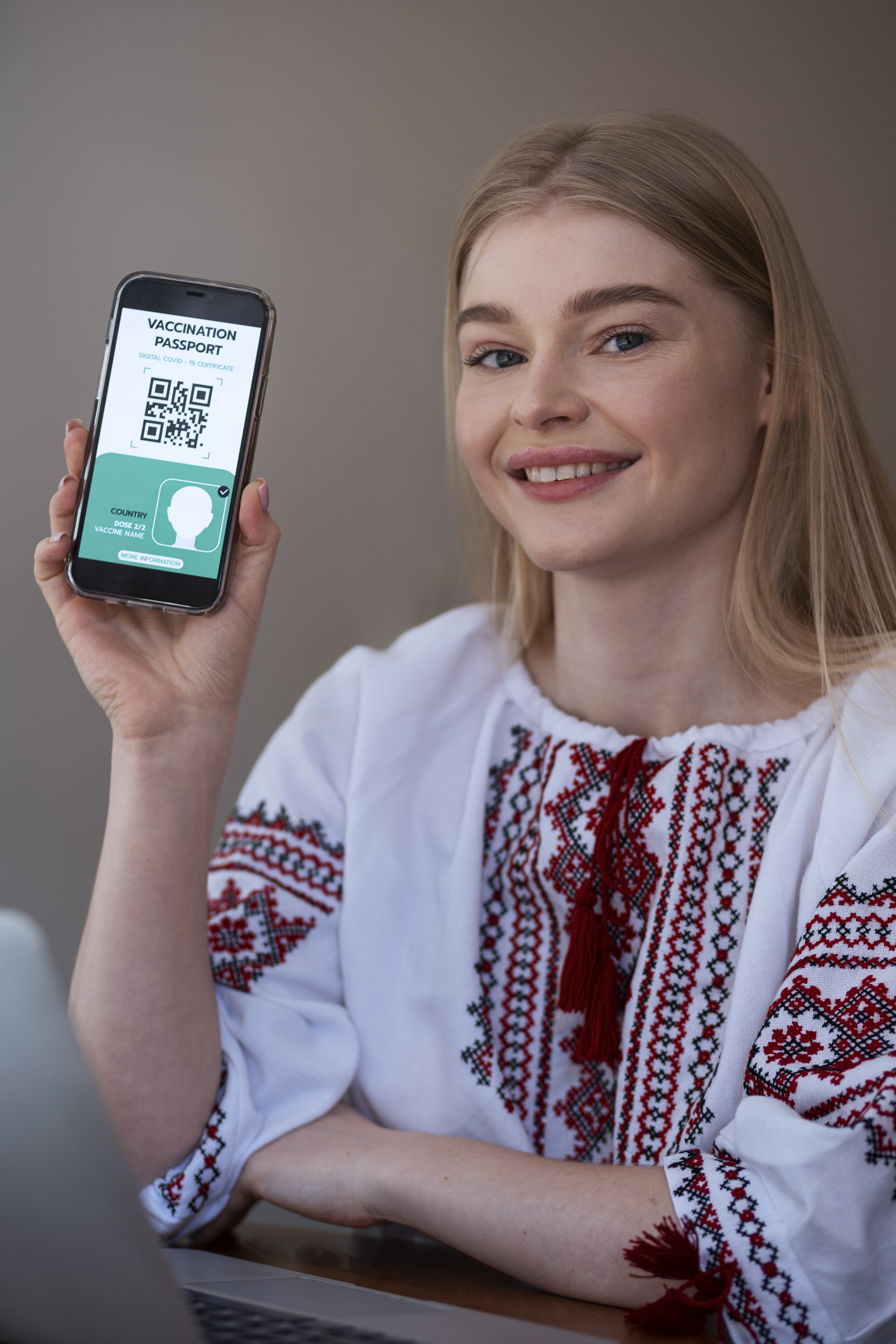Professional woman using smartphone QR code scanner for remote work connectivity and business communications